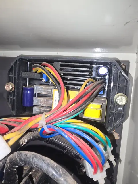 Technician fault-finding the AVR on a commercial standby generator